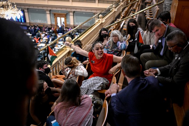 Rep. Elisabeth Epps, center, speaks her mind to Rep. Chris deGruy Kennedy after leaving the floor to join supporters in the House gallery during a special session of the General Assembly at the Colorado Capitol on Monday, Nov. 20, 2023. (Photo by AAron Ontiveroz/The Denver Post)